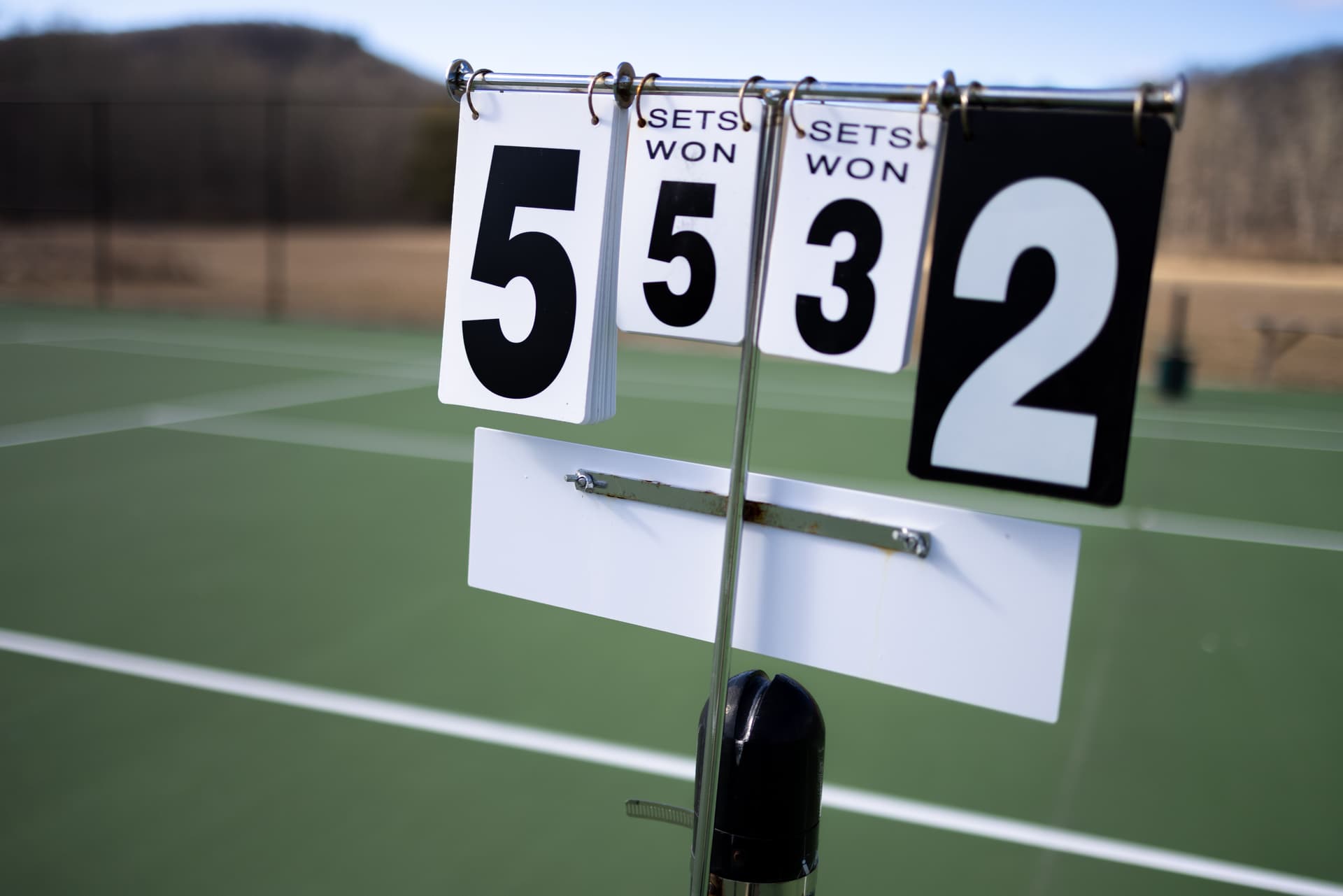 View of outdoor tennis court with scores in view