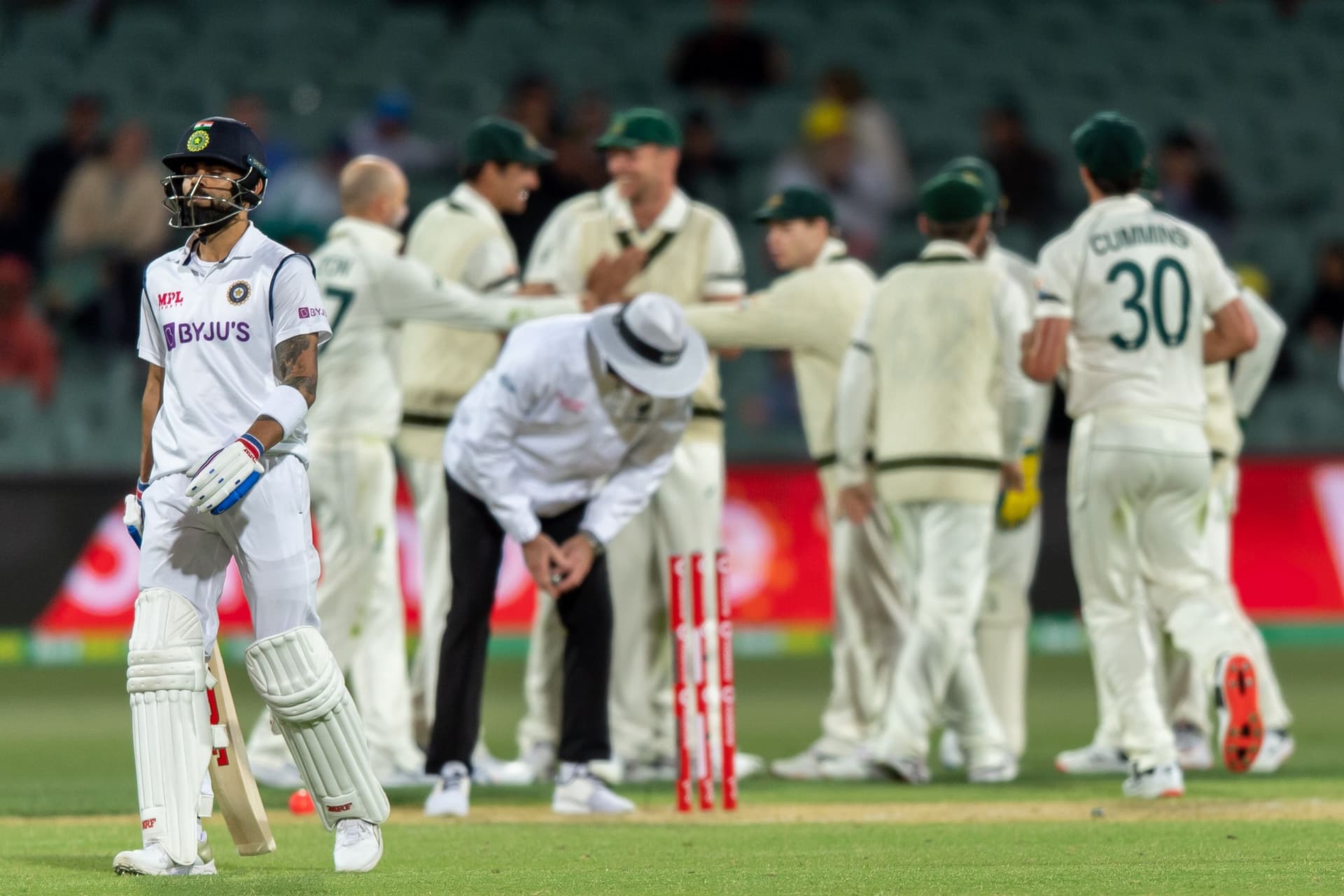 Virat Kohli of India walks off the field after being run-out by Josh Hazlewood of Australia