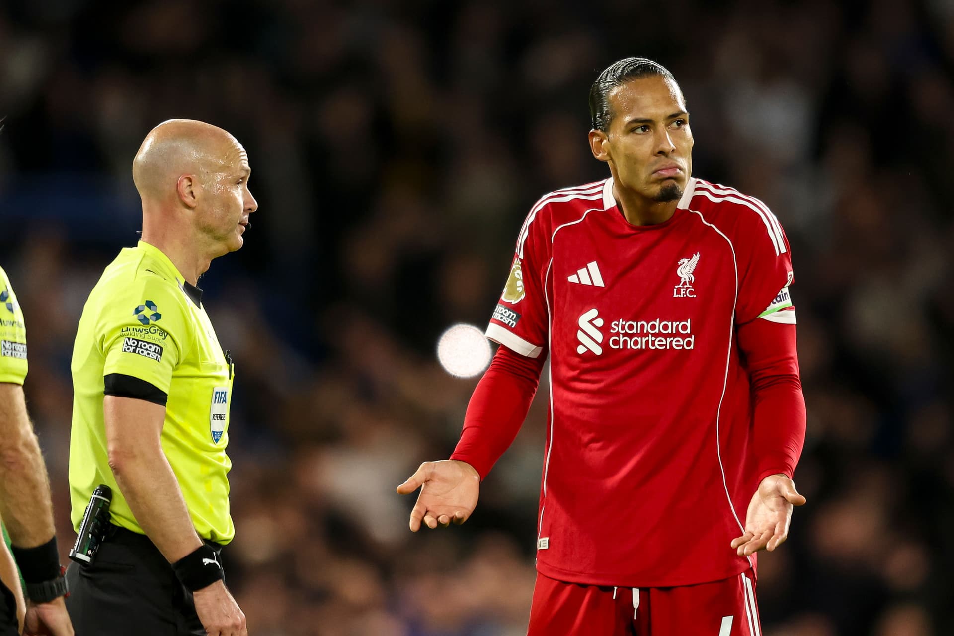 Virgil van Dijk of Liverpool with Referee Anthony Taylor
