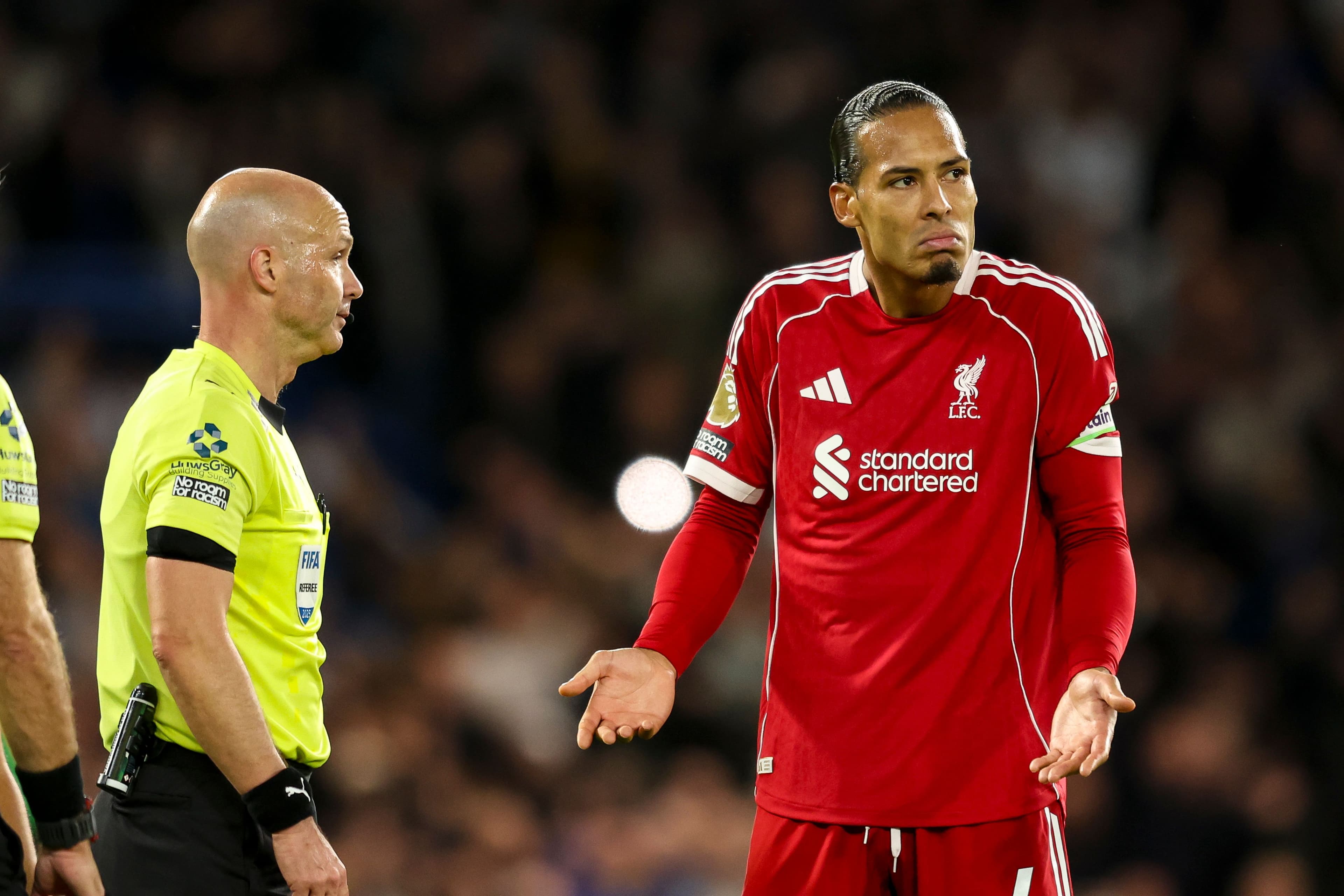 Virgil van Dijk of Liverpool with Referee Anthony Taylor