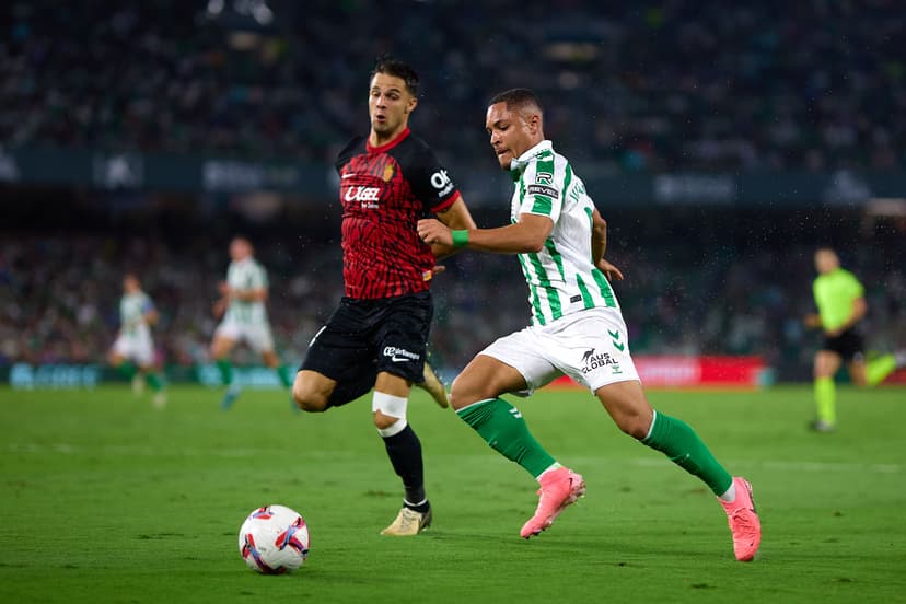 Vitor Roque of Real Betis battles for the ball with Martin Valjen