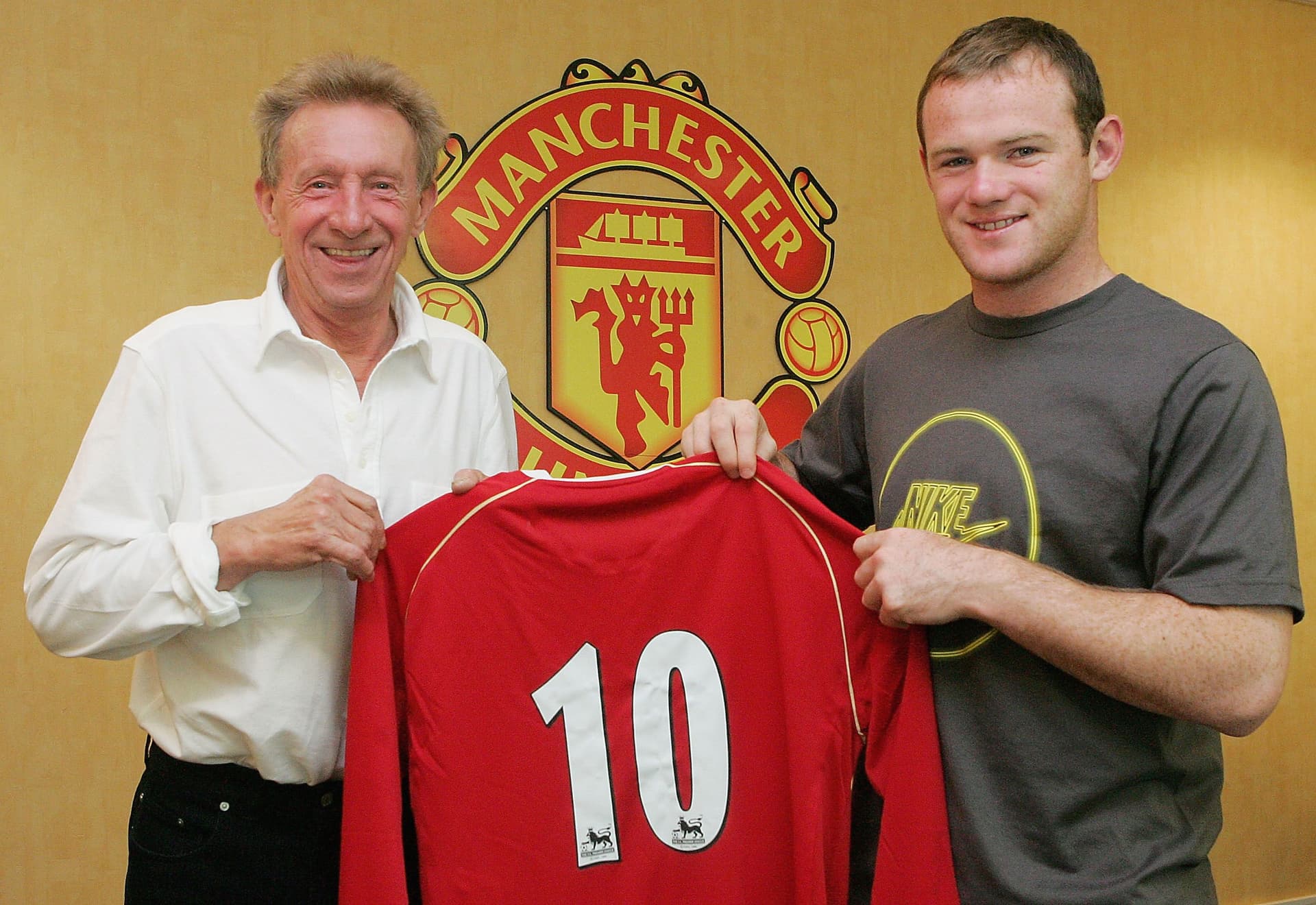 Wayne Rooney of Manchester United poses with United legend Denis Law