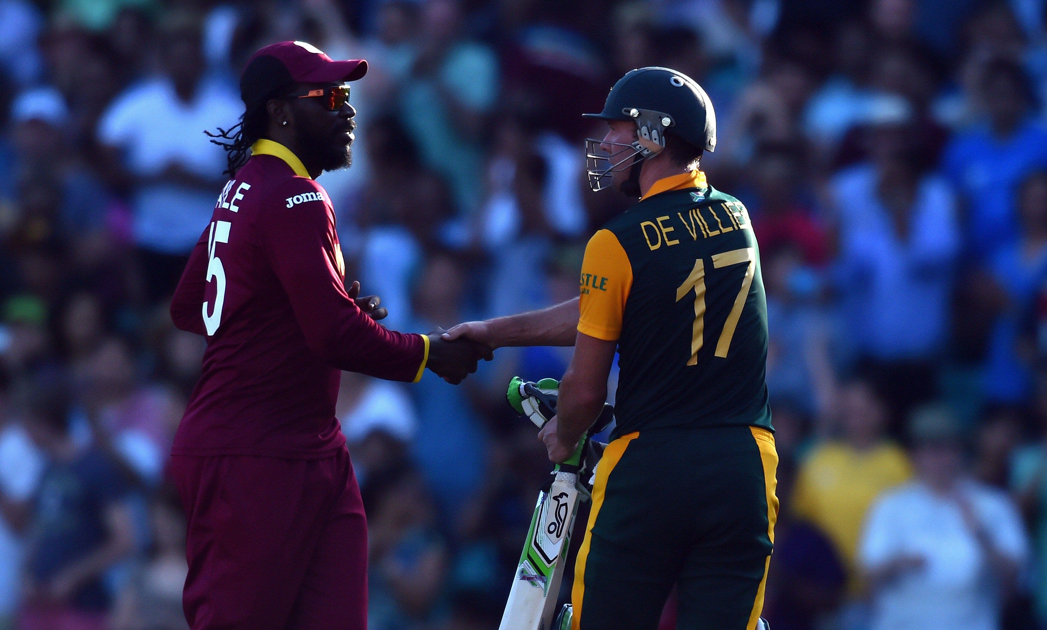West Indies player Chris Gayle (L) congratulates South Africa's batsman AB de Villiers