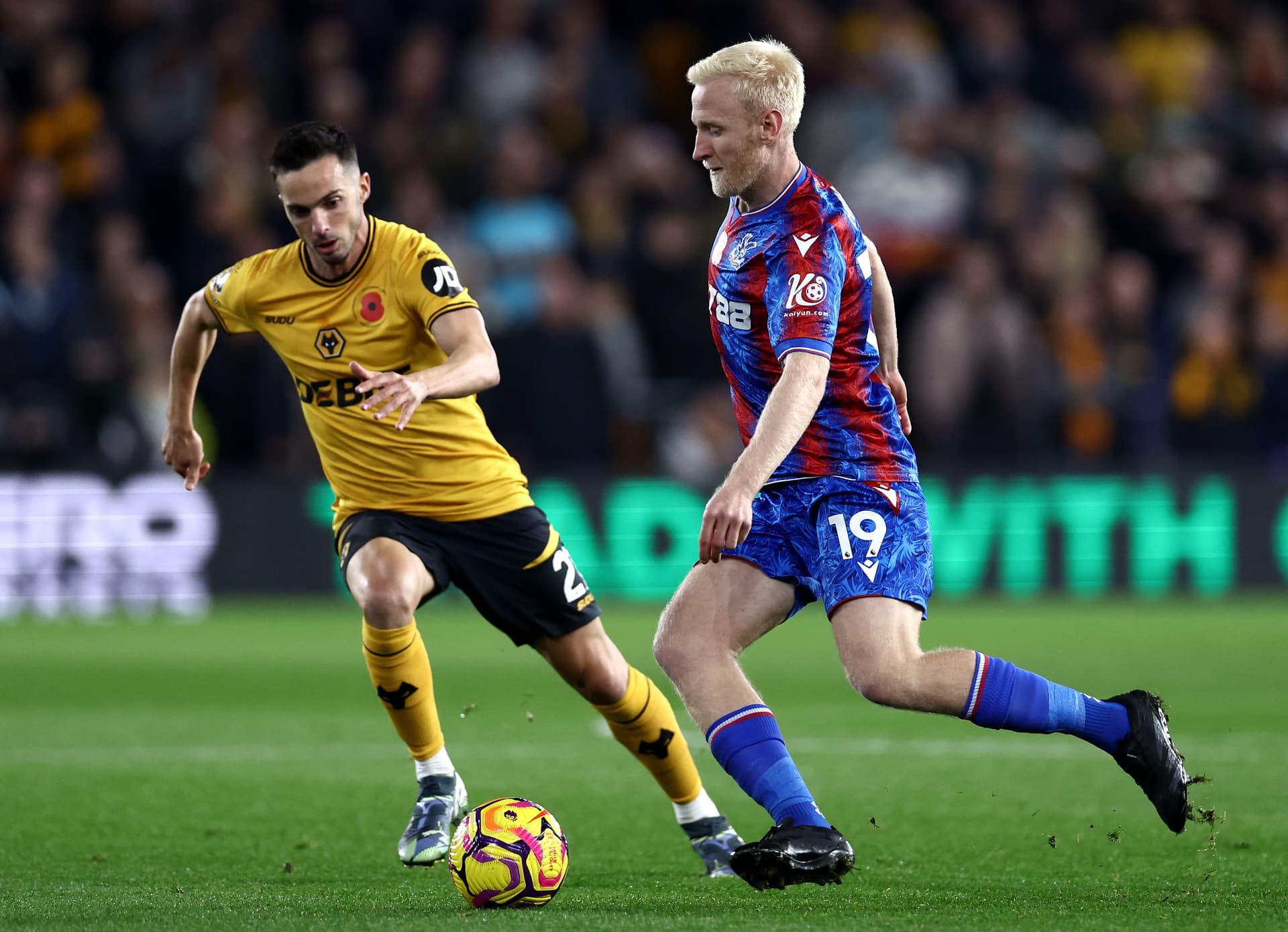 Will Hughes of Crystal Palace runs with the ball whilst under pressure from Pablo Sarabia of Wolverhampton Wanderers