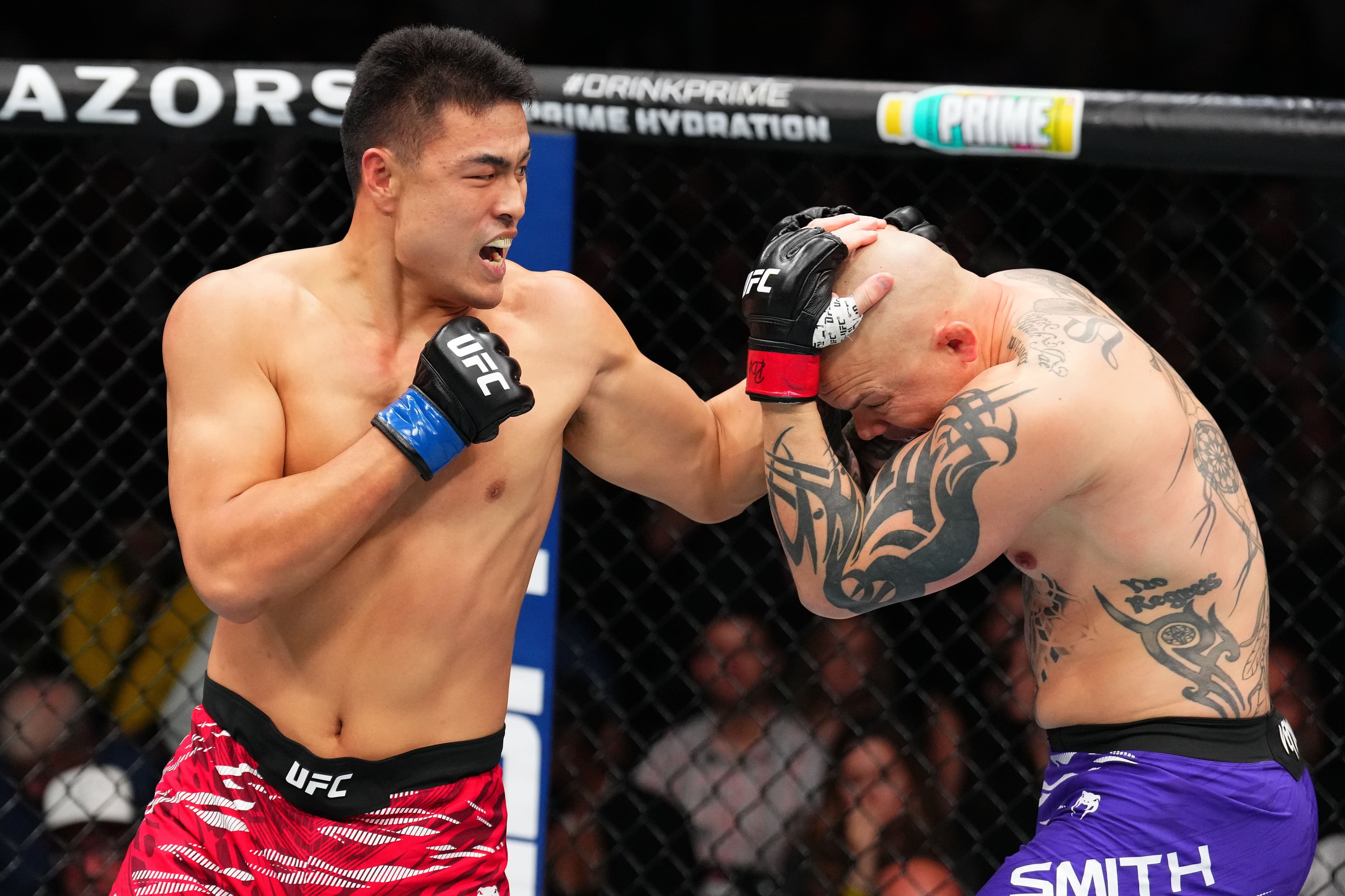 Zhang Mingyang of China punches Anthony Smith in a light heavyweight fight